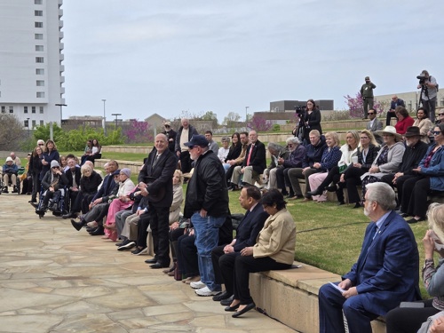 Photo shows dentists standing to be recognized during A Day of Remembrance